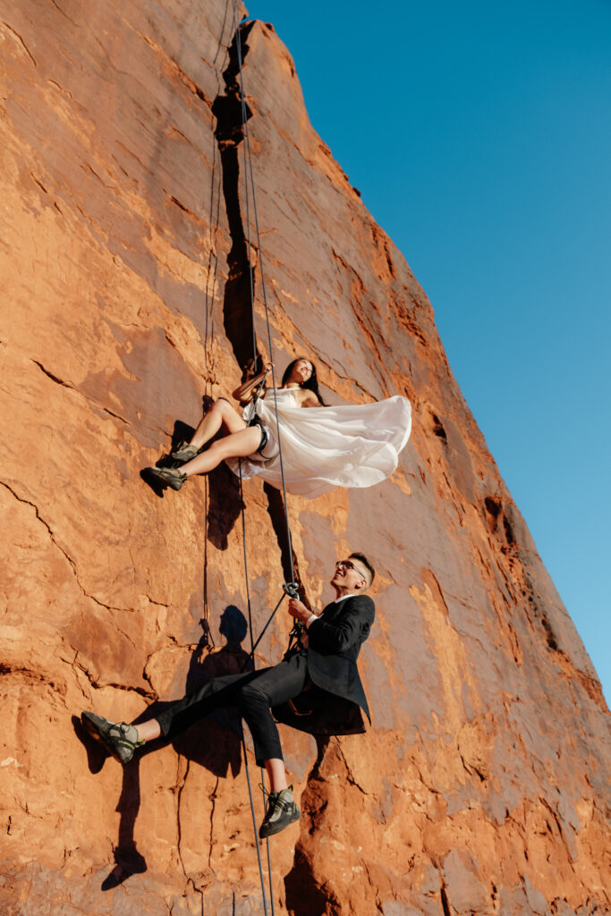 St. George Rappelling bridal session, red rock bridal session, St George bridal session, adventure bridals, red rock wedding photos, unique wedding photos Southern Utah 