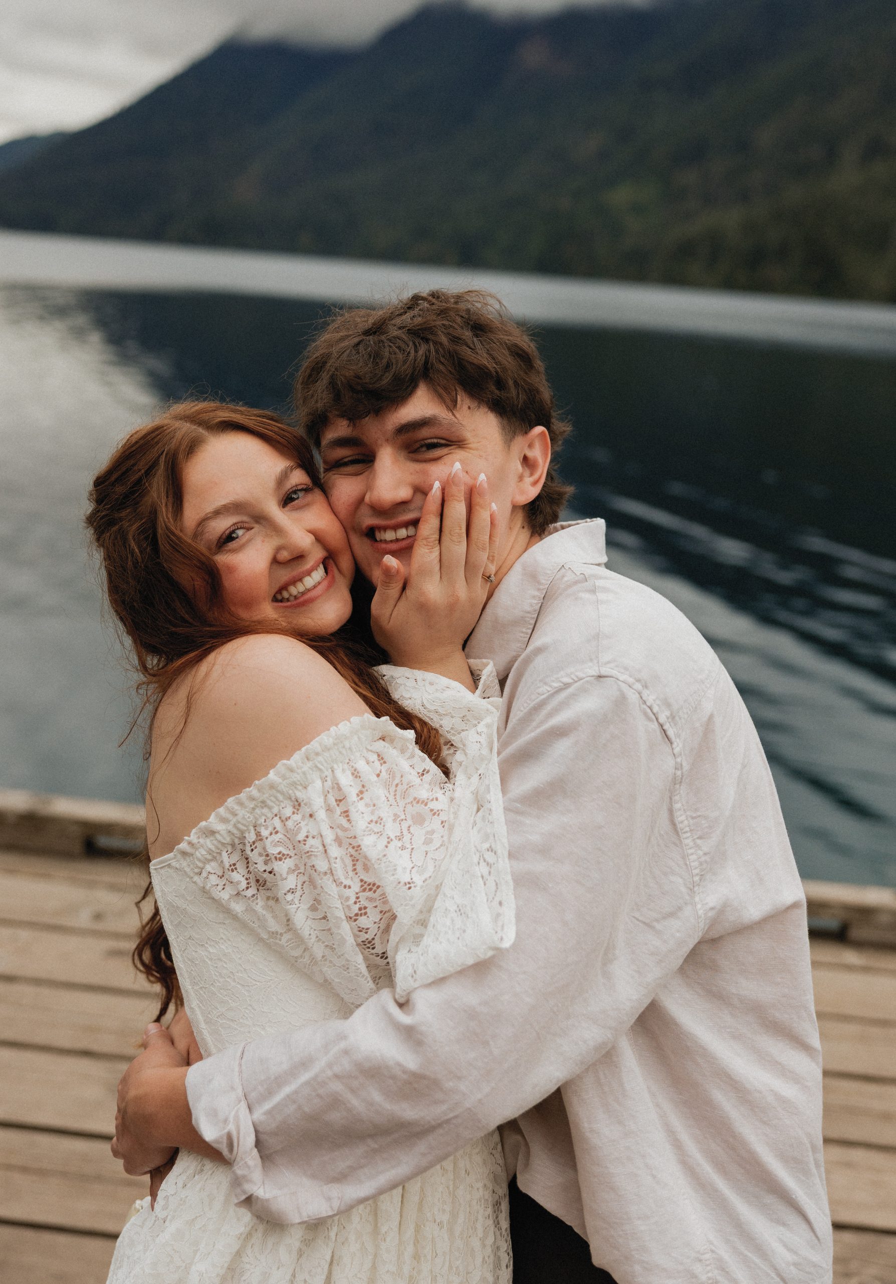 Dakota and Rowdy smiling cheek to cheek on a dock at Lake Crescent